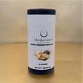 a light blue tube of Instant Mushroom Coffee branded Mariko Grove, decorated with a picture of 2 mushroom people dressed in yellow kimonos enjoying a cup.